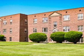 Rochester townhouse for rent - a brick building with green grass in front of it