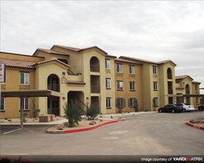Phoenix apartment for rent - A large building with a parking lot in front of it.