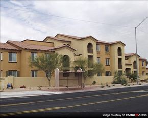 Phoenix apartment for rent - Apartment building with a brown facade and a tree in front.