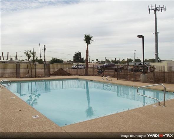 Phoenix apartment for rent - A small pool with a metal fence around it.