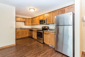Brookings apartment for rent - a kitchen with wooden cabinets and stainless steel appliances