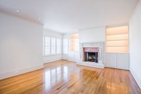 San Francisco apartment for rent - an empty living room with a fireplace and wooden floors