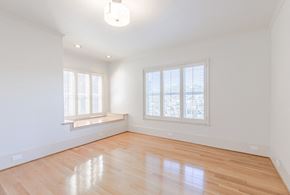 San Francisco apartment for rent - an empty living room with white walls and wood floors and a window