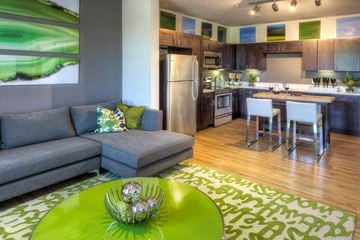Englewood apartment for rent - a living room and kitchen with a green table