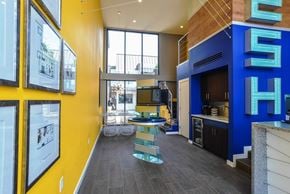 Austin apartment for rent - A modern interior with a blue and yellow wall and a glass table.