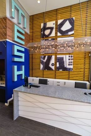Austin apartment for rent - A reception area with a blue sign and a white counter.