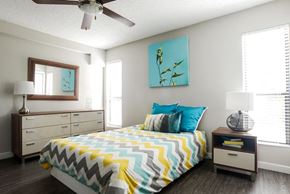 Austin apartment for rent - A bedroom with a bed, dresser, and ceiling fan.