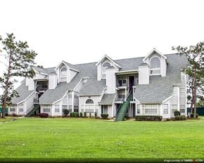 New Orleans apartment for rent - a large house with a green lawn in front of it
