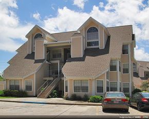 Gretna apartment for rent - a large house with cars parked in front of it