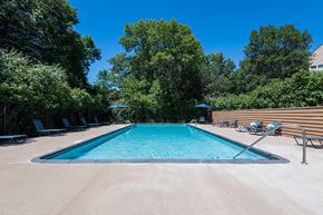 Plymouth apartment for rent - long shot of outdoor pool with trees in the background