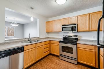 Minnetonka apartment for rent - a kitchen with stainless steel appliances and wooden cabinets