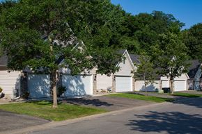 Minnetonka apartment for rent - row of houses with garages and two large trees out front