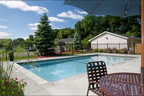 Minnetonka apartment for rent - outdoor pool with deck chair and table with umbrella