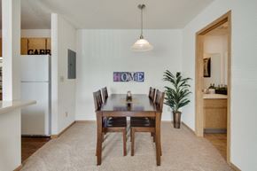 Shakopee apartment for rent - a dining room with a wooden table and chairs