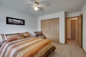 Shakopee apartment for rent - a bedroom with a bed and a ceiling fan