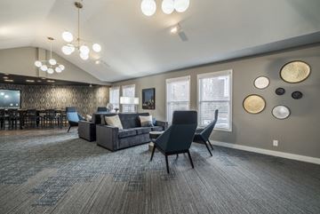 St. Paul apartment for rent - a living room with couches and chairs and a dining room table