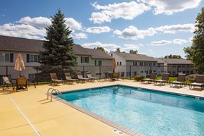 Woodbury townhouse for rent - outdoor pool on a sunny day with multiple deck chairs