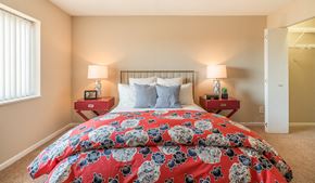 St. Paul apartment for rent - a bedroom with a bed with a red comforter