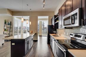 Edina apartment for rent - Kitchen with white tabletops, dark brown cabinets, and modern appliances