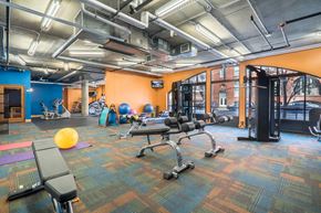Minneapolis apartment for rent - Fitness room with orange and blue walls and lots of different equipment