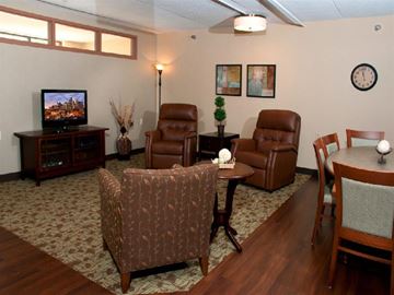 St. Paul apartment for rent - A living room with a brown leather chair and a wooden table.