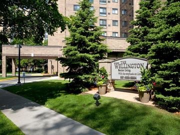 St. Paul apartment for rent - A sign for The Wellington Retirement Living is in front of a building.