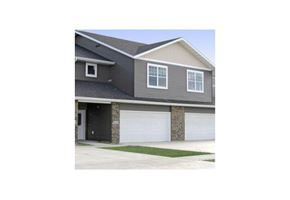 West Fargo townhouse for rent - a house with a garage door and a driveway