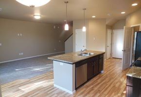West Fargo townhouse for rent - an empty kitchen and living room with a sink