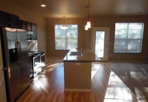 West Fargo townhouse for rent - an empty kitchen with a stainless steel refrigerator