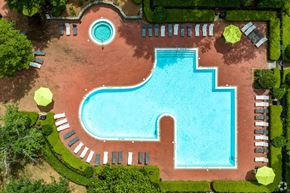 Charlotte apartment for rent - an aerial view of a swimming pool in a garden with trees