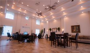 Charlotte apartment for rent - a large conference room with tables and chairs and a ceiling fan
