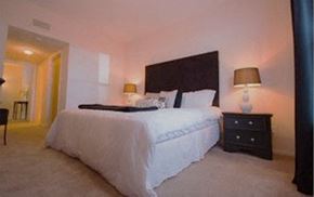 Charlotte apartment for rent - a bedroom with a large bed and a night stand