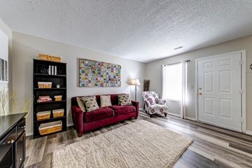 Ofallon apartment for rent - a living room with a couch and a chair and a door
