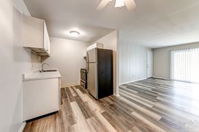 Ofallon apartment for rent - a kitchen with white cabinets and a stainless steel refrigerator