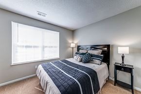 St. Charles apartment for rent - the master bedroom has a large window and a large bed