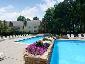 St. Charles apartment for rent - a swimming pool with flowers and chairs around it