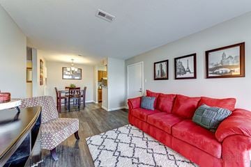 St. Charles apartment for rent - a living room with a red couch and a dining room table