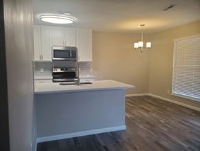 St. Charles apartment for rent - A kitchen with a white countertop and a microwave above it.