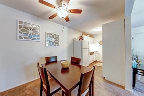 Florissant townhouse for rent - a dining room with a table and a ceiling fan