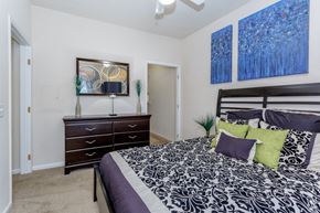 Overland Park apartment for rent - a bedroom with a bed and a dresser