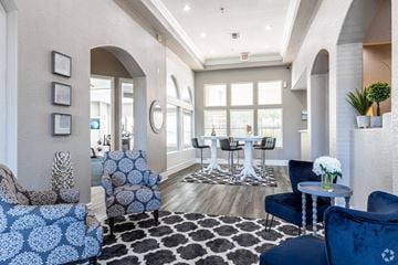Overland Park apartment for rent - a living room with blue furniture and a table with chairs