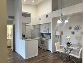 Hallandale Beach apartment for rent - A modern kitchen with a table and chairs.