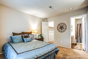 Chesterfield townhouse for rent - the master bedroom has a large bed and a door to the bathroom