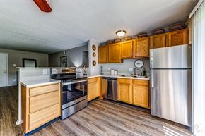 St. Louis apartment for rent - a kitchen with stainless steel appliances and wooden cabinets
