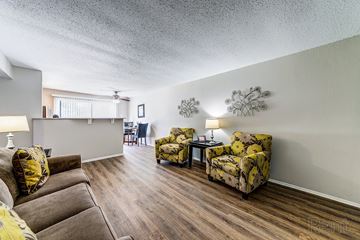 St. Louis apartment for rent - a living room with couches and chairs and a kitchen