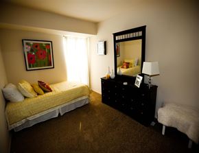 Manchester townhouse for rent - a bedroom with a bed and a dresser with a mirror