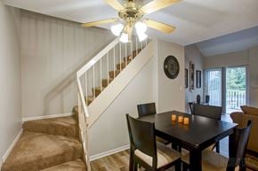 Fairview Heights apartment for rent - a dining room with a table and chairs under a staircase
