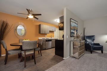 Farmington Hills apartment for rent - a living room with a dining room table and a kitchen