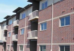 Fargo apartment for rent - a brick building with balconies on the side of it