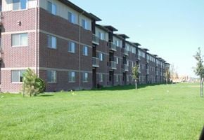 Fargo apartment for rent - a brick apartment building with green grass in front of it